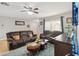 Comfortable living room featuring plush seating, a ceiling fan, and stylish décor, ideal for relaxation and entertainment at 10934 Tangora St, Orlando, FL 32825