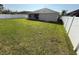 View of the expansive back yard with a white vinyl fence at 1115 Fidelma Ct, Orlando, FL 32824