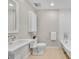 Bright bathroom with a pedestal sink, a tiled shower, and a freestanding bathtub at 1130 Washington Ave # 11, Winter Park, FL 32789