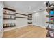 Bedroom with hardwood floors, modern ceiling fan, and custom built-in shelving at 1130 Washington Ave # 11, Winter Park, FL 32789