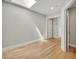 Well lit bedroom with hardwood flooring and open door to the hallway at 1130 Washington Ave # 11, Winter Park, FL 32789