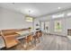 Bright dining area features wood floors, a built-in bench, and a contemporary light fixture at 1130 Washington Ave # 11, Winter Park, FL 32789