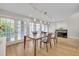 Sunlit dining area with floor-to-ceiling windows, hardwood floors, and contemporary furnishings creates an elegant setting at 1130 Washington Ave # 11, Winter Park, FL 32789