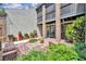 A ground-level exterior shot showcasing a townhouse entrance with a small patio and colorful potted plants at 1130 Washington Ave # 11, Winter Park, FL 32789
