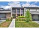 Inviting townhome with a brick facade, small front yard, and an accessible walkway leading to the front door at 1130 Washington Ave # 11, Winter Park, FL 32789