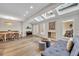 Open living room with wood floors, skylights, a fireplace, and a dining area with a built-in bench at 1130 Washington Ave # 11, Winter Park, FL 32789