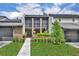 Charming townhome featuring brick accents, double balconies, and a beautifully landscaped front yard at 1130 Washington Ave # 11-C, Winter Park, FL 32789