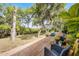 Expansive backyard deck with lounge seating, mature trees and lush landscaping with views of the marsh at 1200 Auger Dr, New Smyrna Beach, FL 32168