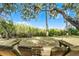Backyard swing with views of the marsh and native landscaping, shaded by mossy trees on a sunny day at 1200 Auger Dr, New Smyrna Beach, FL 32168
