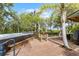 Wooden deck with a hot tub surrounded by tropical landscaping creates a private outdoor oasis at 1200 Auger Dr, New Smyrna Beach, FL 32168