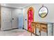 Bright entryway featuring a unique red-tinted door, decorative water feature, and rustic wood console table at 1200 Auger Dr, New Smyrna Beach, FL 32168