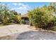 Single-story home with a well-manicured lawn, mature landscaping, and a long driveway leading to a two-car garage at 1200 Auger Dr, New Smyrna Beach, FL 32168