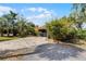 A single-Gathering home featuring a well-maintained lawn, mature landscaping, and a two-car garage at 1200 Auger Dr, New Smyrna Beach, FL 32168
