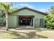 Large garage with sliding door providing ample space for storage, projects, and parking at 1200 Auger Dr, New Smyrna Beach, FL 32168