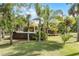 Backyard tropical paradise featuring lush landscaping and a hot tub, creating a serene outdoor retreat at 1200 Auger Dr, New Smyrna Beach, FL 32168