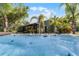 Enjoy the expansive tropical backyard oasis featuring a tranquil hot tub, perfect for relaxing and unwinding at 1200 Auger Dr, New Smyrna Beach, FL 32168