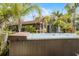 The hot tub in the tropical backyard oasis provides a tranquil retreat surrounded by lush landscaping at 1200 Auger Dr, New Smyrna Beach, FL 32168