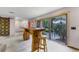 Open kitchen featuring a custom island with seating, stainless appliances, and access to the patio at 1200 Auger Dr, New Smyrna Beach, FL 32168