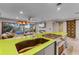 Modern kitchen features bright green countertops, gas range and view to the living room at 1200 Auger Dr, New Smyrna Beach, FL 32168