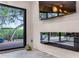 Living room with modern fireplace, large window, and outdoor deck access at 1200 Auger Dr, New Smyrna Beach, FL 32168