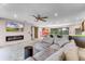 Spacious living room with fireplace, ceiling fan, and views into the dining area at 1200 Auger Dr, New Smyrna Beach, FL 32168