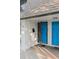 This house features a brightly-colored blue front door, a storm door, and brick accents at 1210 Maury Rd # 3, Orlando, FL 32804