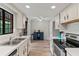 Well-lit kitchen showcasing white cabinets, appliances, and wood-look flooring, adjoining an eating area at 1210 Maury Rd # 3, Orlando, FL 32804
