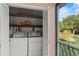 The laundry room features a washer and dryer, shelves, and natural light with a view of the outdoors at 1210 Maury Rd # 3, Orlando, FL 32804
