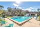 Sparkling community pool surrounded by lounge chairs and tropical landscaping for relaxation at 1210 Maury Rd # 3, Orlando, FL 32804