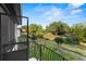 Balcony view overlooking the manicured lawn and verdant landscaping in a serene community setting at 1210 Maury Rd # 3, Orlando, FL 32804