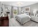 Serene bedroom with plush bedding, a cozy atmosphere, and a picturesque window view at 12966 Promise Pl, Orlando, FL 32832