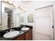 Bathroom features double sinks, granite countertop, and a separate door to a walk-in closet at 145 Palazzo Ln, Kissimmee, FL 34759