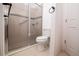 Bathroom with glass-enclosed shower featuring tiled walls, mosaic accents, and modern fixtures at 145 Palazzo Ln, Kissimmee, FL 34759