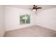 Bright bedroom featuring a ceiling fan and a large window providing ample natural light at 145 Palazzo Ln, Kissimmee, FL 34759
