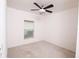 Clean, well-lit bedroom featuring a modern ceiling fan and a window with horizontal blinds at 145 Palazzo Ln, Kissimmee, FL 34759