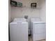 Laundry room equipped with a washer and dryer and featuring ample shelving for storage at 145 Palazzo Ln, Kissimmee, FL 34759