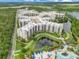 Stunning aerial view of a luxurious condominium complex with lush landscaping and a serene lakefront setting at 14501 Grove Resort Ave # 2438, Winter Garden, FL 34787