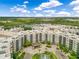 Stunning aerial view of a luxurious condo complex with lush landscaping and a picturesque lake at 14501 Grove Resort Ave # 2438, Winter Garden, FL 34787