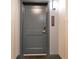 Gray apartment door with unit number and modern hardware at 14501 Grove Resort Ave # 2438, Winter Garden, FL 34787