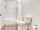 Clean bathroom with a shower-tub combination, modern white tiling, and wood-look flooring at 14501 Grove Resort Ave # 2438, Winter Garden, FL 34787