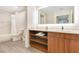 Bright bathroom featuring a vanity with open shelving, ample counter space and a shower/tub combo at 14501 Grove Resort Ave # 2438, Winter Garden, FL 34787