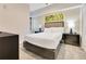 Cozy bedroom features plush bedding, modern decor, and convenient bedside tables with lamps at 14501 Grove Resort Ave # 2438, Winter Garden, FL 34787