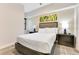 Well-lit bedroom with stylish headboard, bedside tables, contemporary art, and soft carpet at 14501 Grove Resort Ave # 2438, Winter Garden, FL 34787