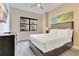 Bright bedroom features neutral tones, a comfortable bed, and a window with exterior views at 14501 Grove Resort Ave # 2438, Winter Garden, FL 34787