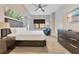 Comfortable bedroom features a king bed, modern decor, and a ceiling fan for added comfort at 14501 Grove Resort Ave # 2438, Winter Garden, FL 34787