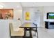 Modern dining area with booth seating and view into the kitchen at 14501 Grove Resort Ave # 2438, Winter Garden, FL 34787
