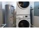 Convenient laundry area features a stacked washer and dryer unit, and water heater at 14501 Grove Resort Ave # 2438, Winter Garden, FL 34787