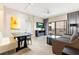 Comfortable living room with gray sofa, dining area, and balcony access at 14501 Grove Resort Ave # 2438, Winter Garden, FL 34787