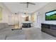 Modern living room with gray sofa, dining area, and open floor plan at 14501 Grove Resort Ave # 2438, Winter Garden, FL 34787
