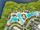 Aerial view of the multi-pool resort area, with lush landscaping, sun loungers, and relaxation spaces by the lake at 14501 Grove Resort Ave # 2438, Winter Garden, FL 34787